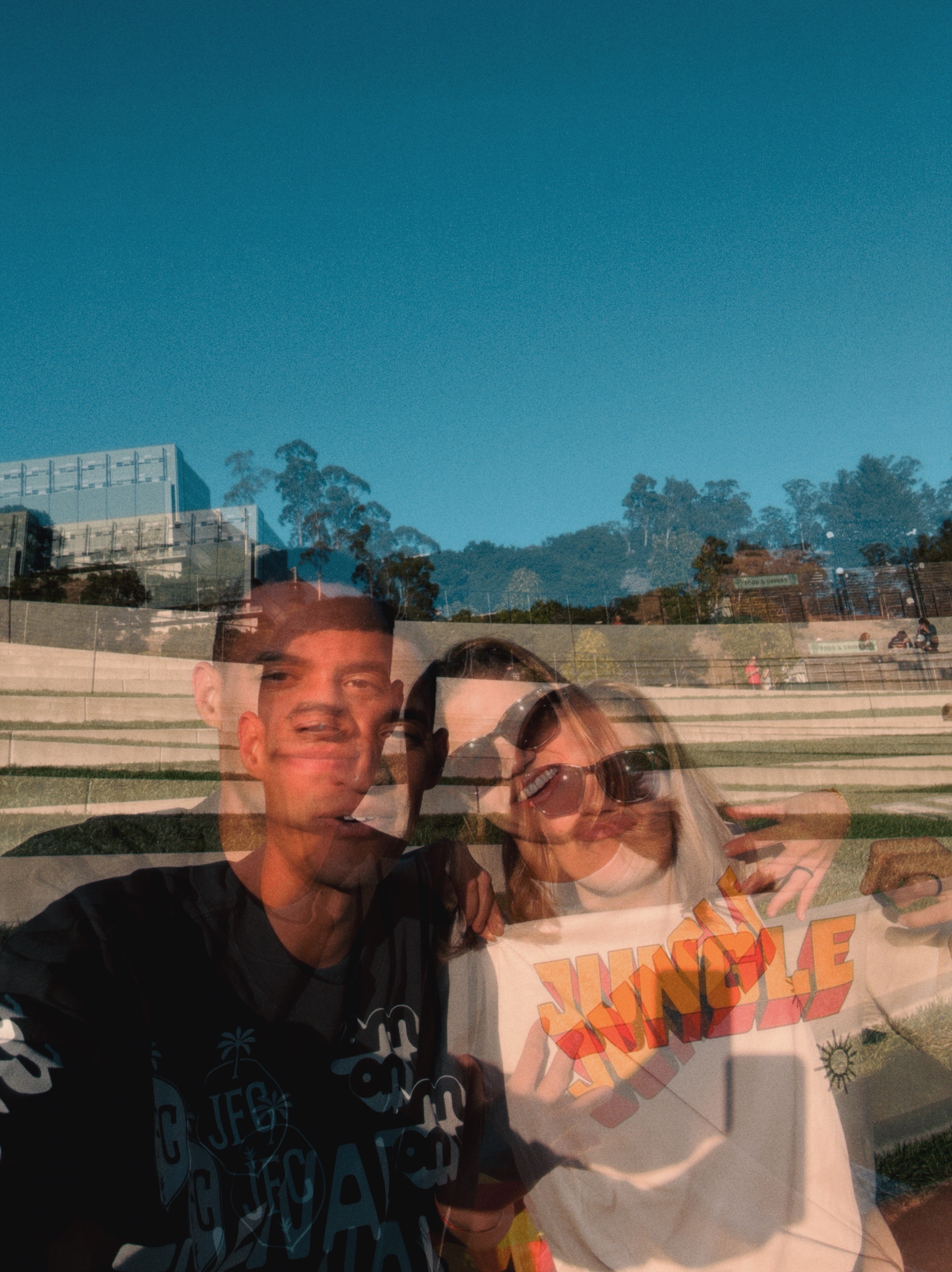 A blurry long expose selfie of myself sitting at the Greek theater pavilion with the blue sky above me
